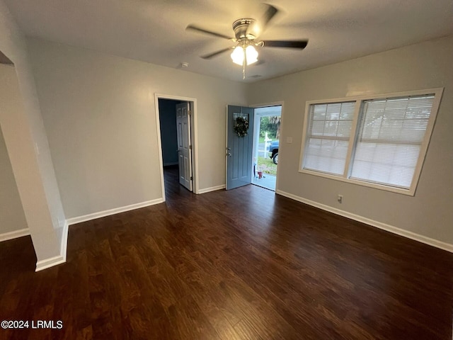 spare room featuring ceiling fan and dark hardwood / wood-style flooring