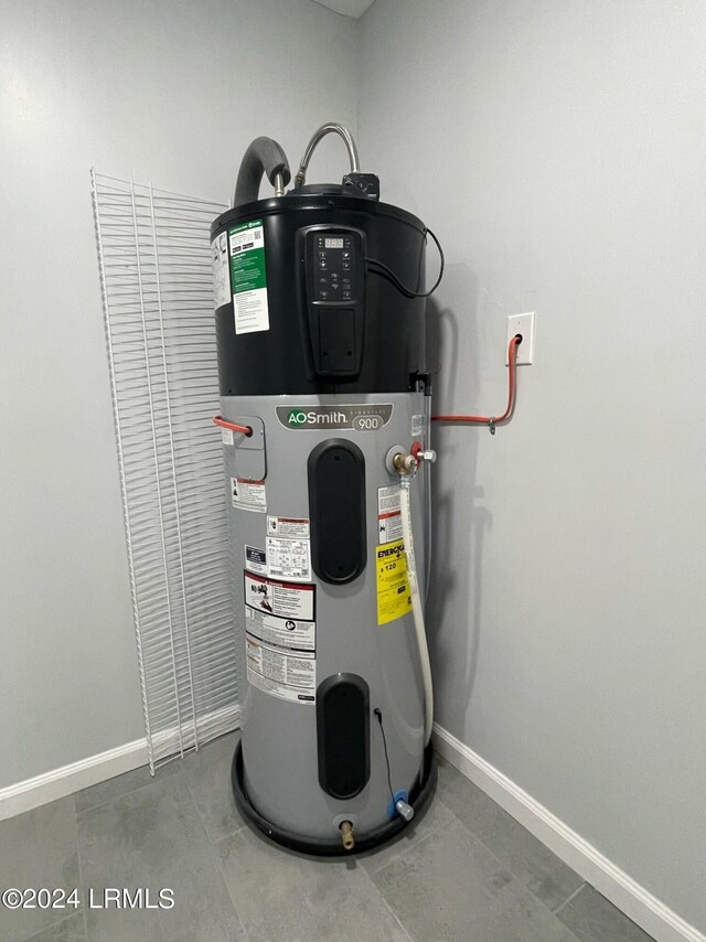 utility room featuring hybrid water heater