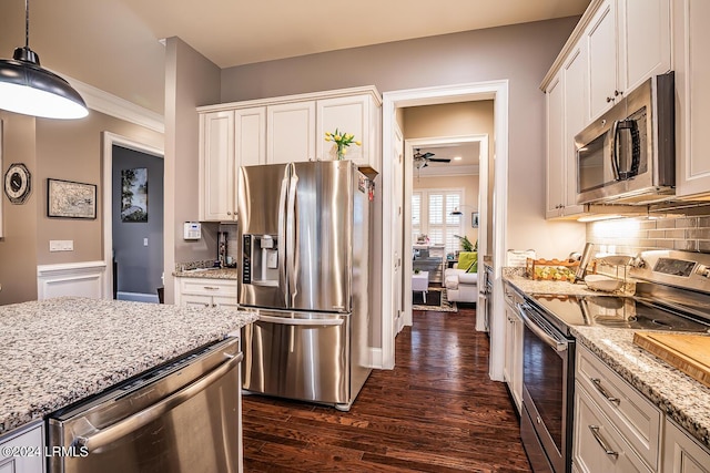 15 Carter Oaks Dr, Beaufort, SC 29907 - kitchen with decorative light fixtures, appliances with stainless steel finishes, dark hardwood / wood-style floors, light stone countertops, and white cabinets