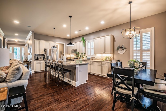 15 Carter Oaks Dr, Beaufort, SC 29907 - kitchen with a breakfast bar area, a kitchen island, pendant lighting, light stone countertops, and decorative backsplash