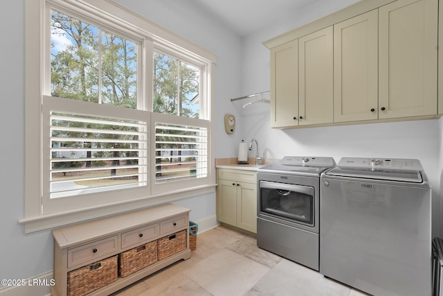 washroom with separate washer and dryer, sink, cabinets, and light tile patterned flooring