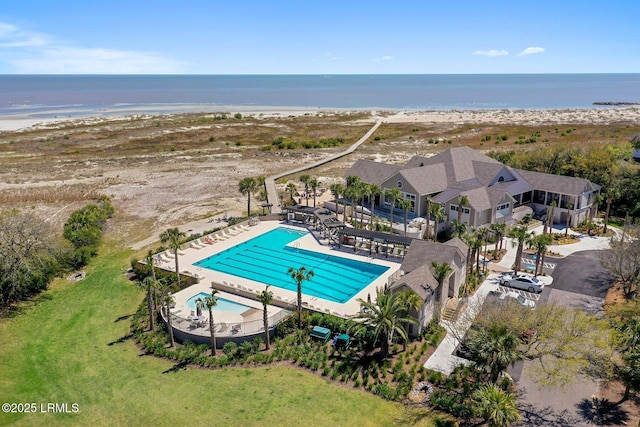 bird's eye view with a water view and a beach view