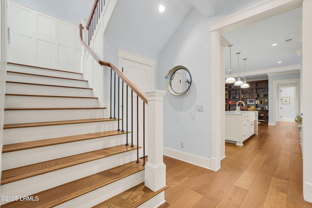 stairway featuring sink and hardwood / wood-style floors