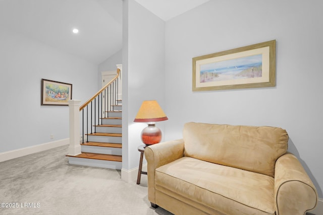 living area with high vaulted ceiling and light carpet