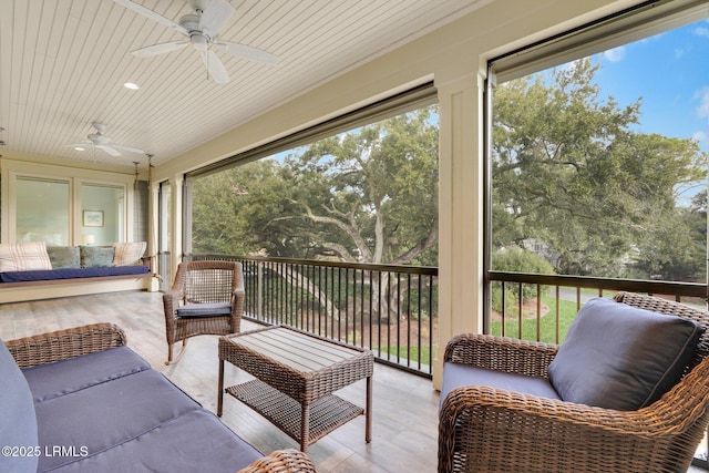 sunroom / solarium featuring a healthy amount of sunlight, wood ceiling, and ceiling fan