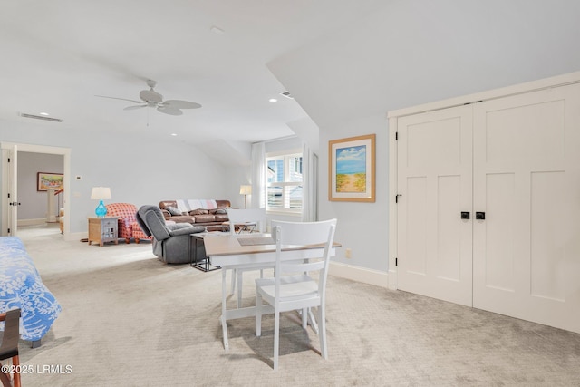 carpeted dining area with ceiling fan