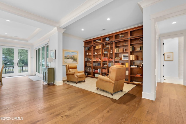 sitting room with crown molding, light hardwood / wood-style floors, and french doors