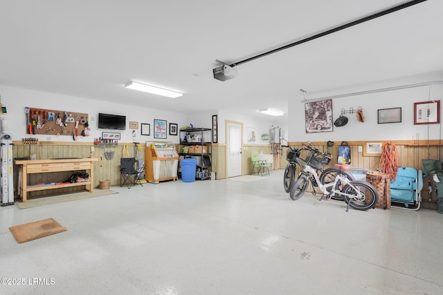 garage featuring a garage door opener and a workshop area