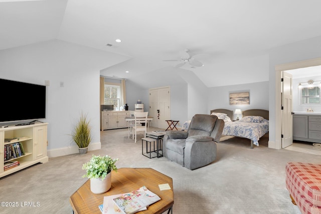 living room with light carpet, sink, vaulted ceiling, and ceiling fan