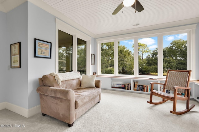 sunroom / solarium featuring ceiling fan