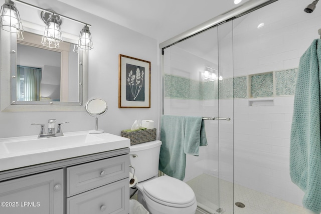 bathroom featuring walk in shower, vanity, and toilet