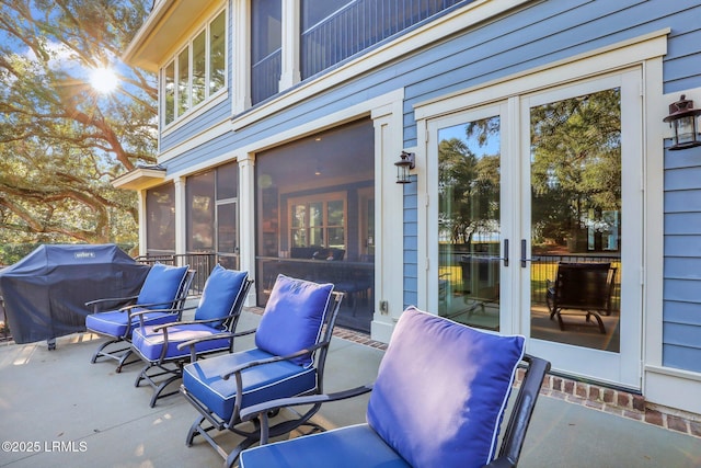 view of patio with a sunroom and area for grilling