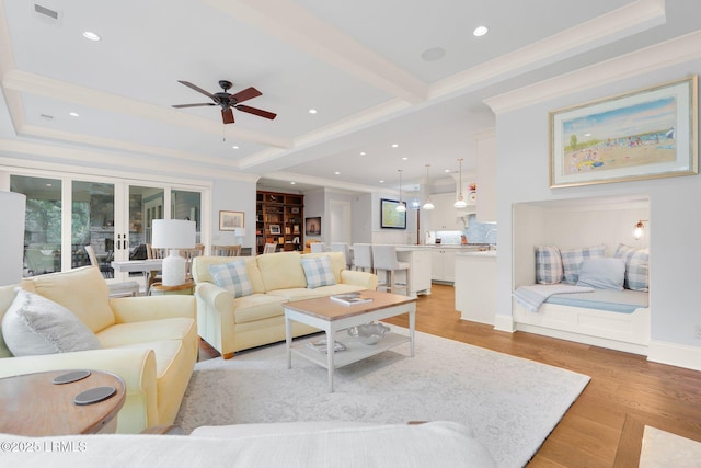 living room with crown molding, ceiling fan, beam ceiling, light hardwood / wood-style floors, and french doors