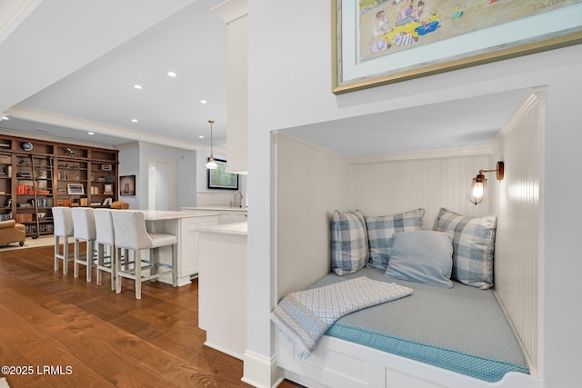 bedroom featuring dark hardwood / wood-style flooring, connected bathroom, and crown molding