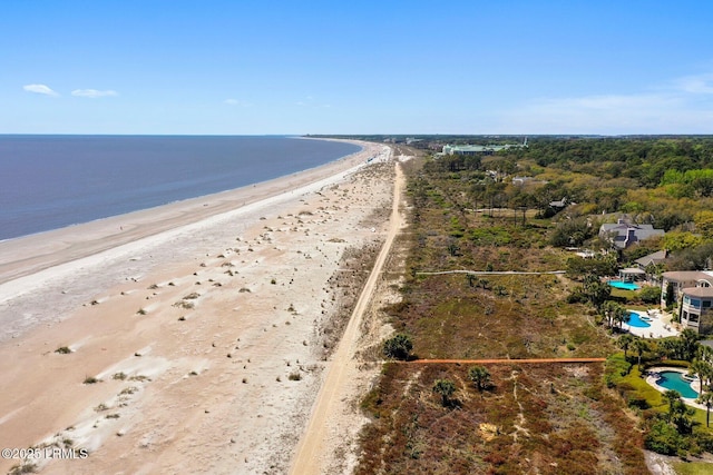 birds eye view of property with a water view and a view of the beach