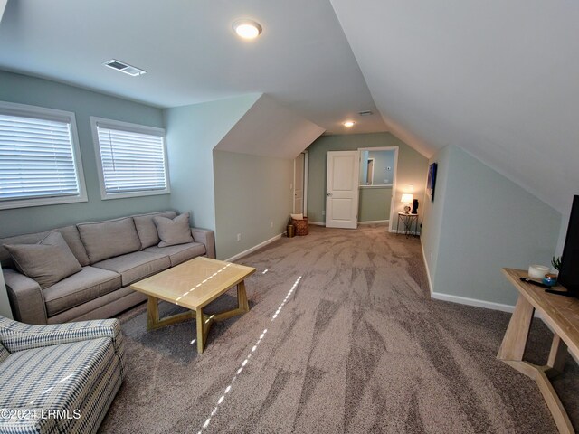 living room with vaulted ceiling and carpet