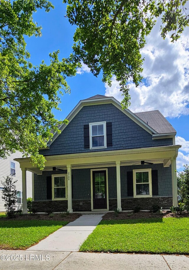 view of front of property with a porch and a lawn