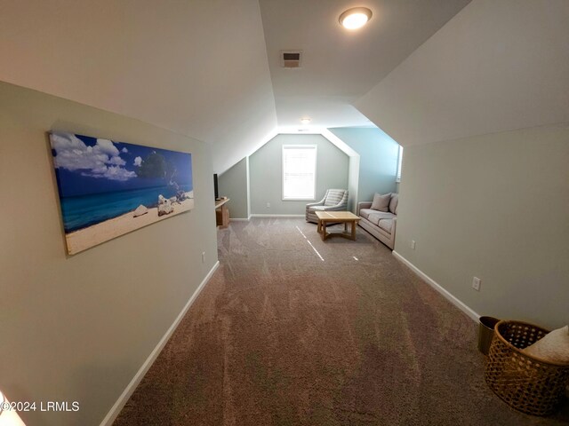 additional living space featuring lofted ceiling and carpet floors