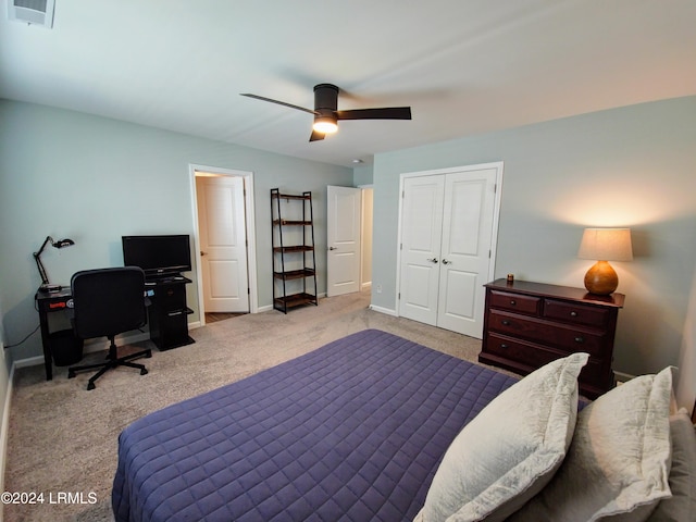 bedroom featuring ceiling fan, light colored carpet, and a closet