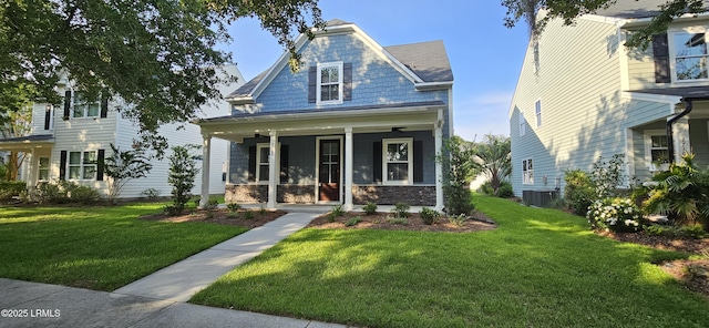 2708 Satilla Blvd, Beaufort, SC 29902 - view of front of house featuring covered porch, a front lawn, stone siding, and cooling unit