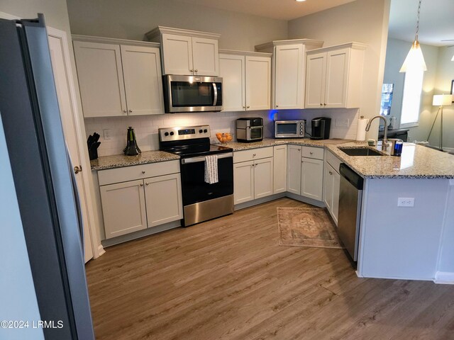 kitchen featuring appliances with stainless steel finishes, sink, and white cabinets