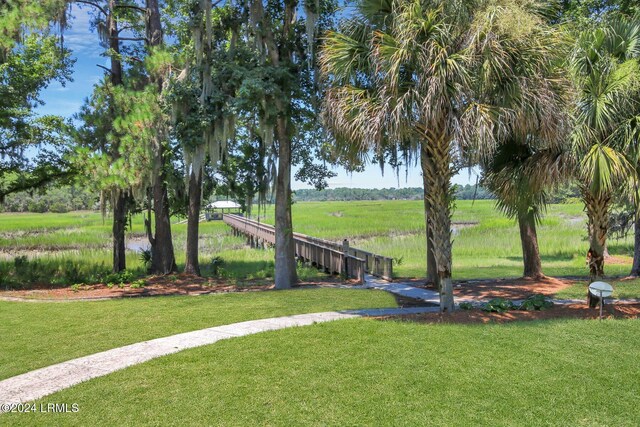 view of home's community with a rural view and a yard