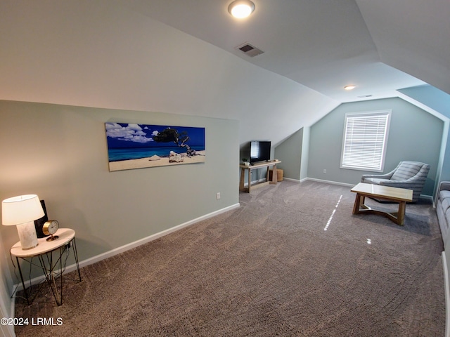 sitting room with vaulted ceiling and carpet flooring