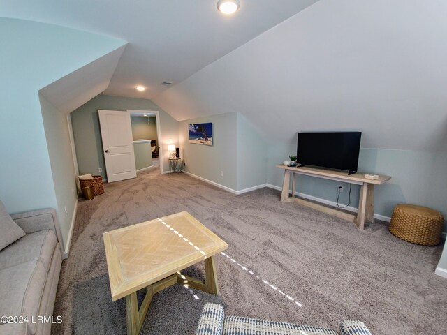 living room with lofted ceiling and carpet floors