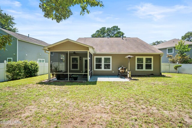 12 Catawba Way, Beaufort, SC 29906 - back of house with a sunroom, a ceiling fan, a fenced backyard, a patio area, and a shingled roof