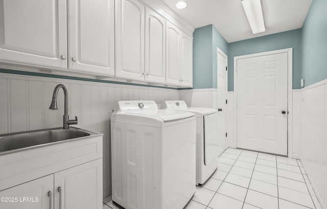 27 Tulifinny Ln, Yemassee, SC 29945 - laundry area with washer and clothes dryer, wainscoting, cabinet space, and light tile patterned floors