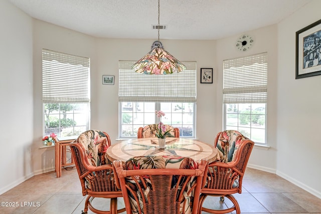 21 Raven Glass Ln, Bluffton, SC 29909 - dining room with light tile patterned flooring, a textured ceiling, and baseboards