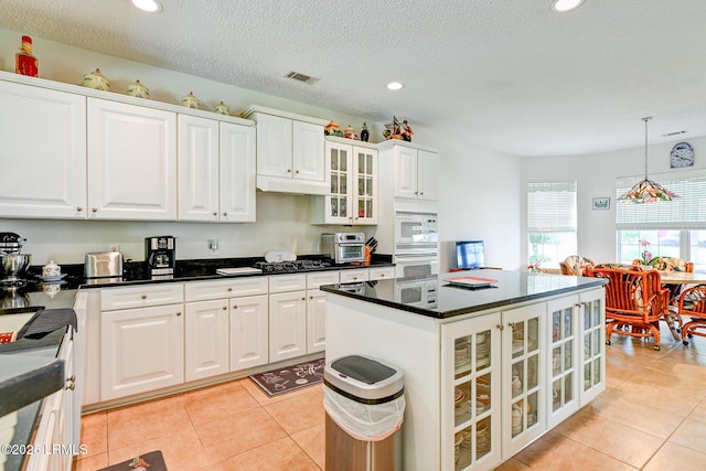 21 Raven Glass Ln, Bluffton, SC 29909 - kitchen with light tile patterned floors, white cabinetry, pendant lighting, dark countertops, and recessed lighting