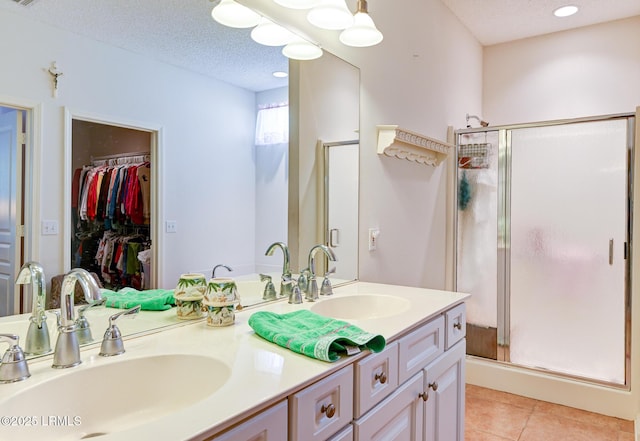 21 Raven Glass Ln, Bluffton, SC 29909 - full bath with a shower stall, double vanity, tile patterned flooring, a textured ceiling, and a walk in closet