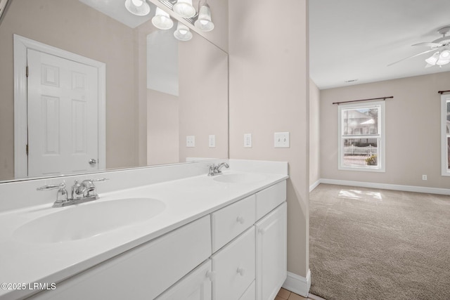 bathroom with vanity and ceiling fan with notable chandelier