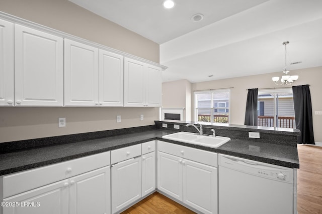 kitchen featuring white cabinetry, sink, kitchen peninsula, and dishwasher