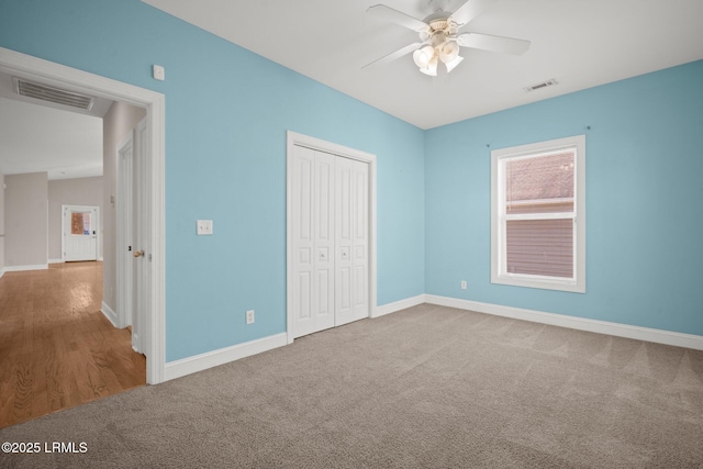 unfurnished bedroom featuring ceiling fan, a closet, and carpet