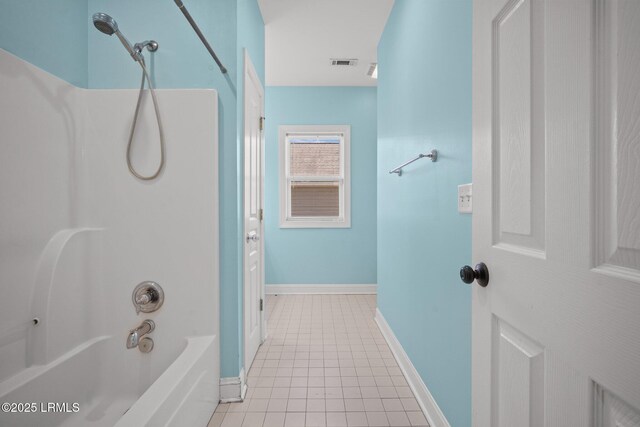 bathroom with tile patterned flooring and shower / tub combination