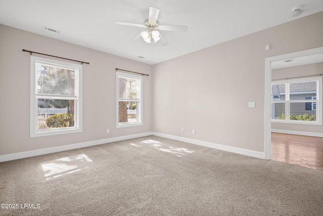 carpeted spare room with ceiling fan