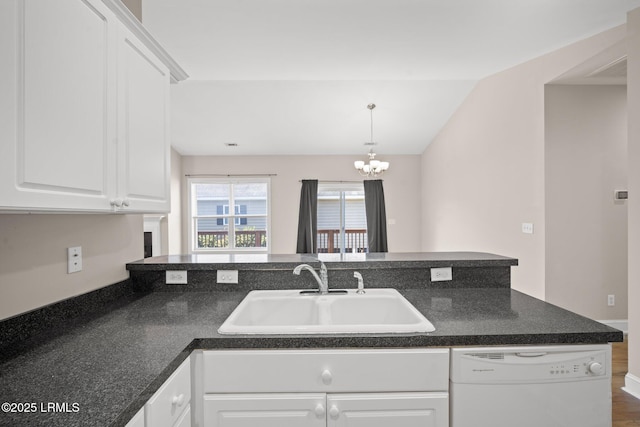 kitchen featuring sink, white cabinetry, an inviting chandelier, white dishwasher, and pendant lighting