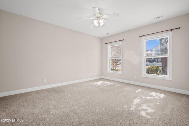 carpeted empty room featuring ceiling fan