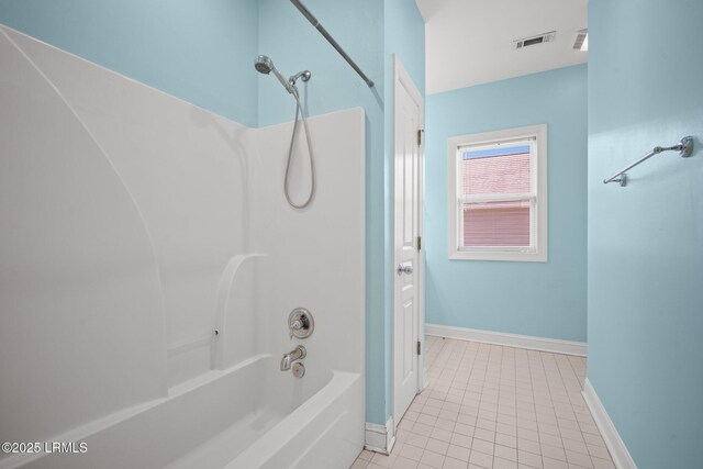 bathroom with tile patterned flooring and washtub / shower combination