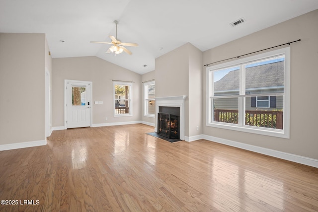 unfurnished living room featuring ceiling fan, vaulted ceiling, and light hardwood / wood-style flooring