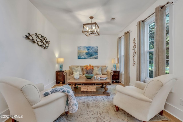 living area featuring hardwood / wood-style flooring and a notable chandelier