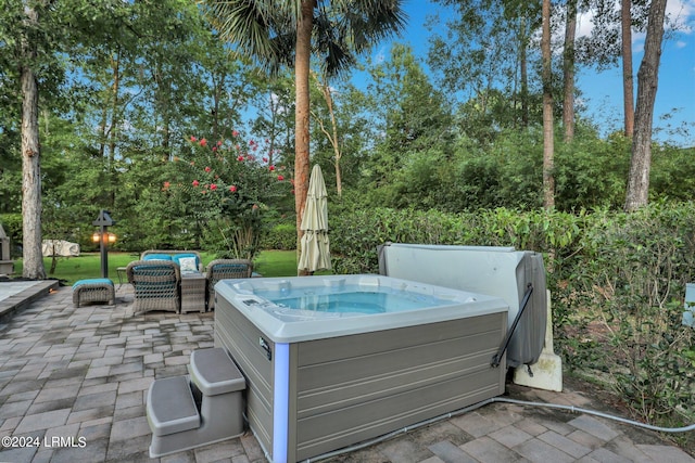 view of patio / terrace with a hot tub and an outdoor living space