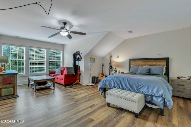 bedroom with lofted ceiling, hardwood / wood-style floors, and ceiling fan