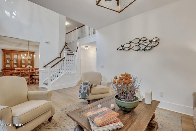 living room with a chandelier and light hardwood / wood-style floors