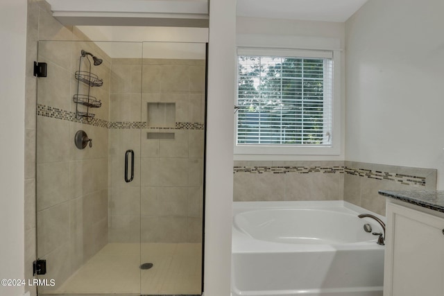 bathroom with plus walk in shower, plenty of natural light, and vanity