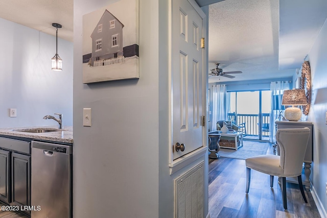 hallway featuring sink, a textured ceiling, and dark hardwood / wood-style flooring