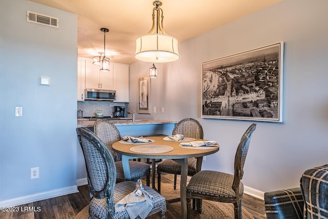 dining room featuring dark wood-type flooring