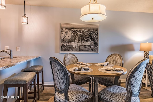 dining area featuring sink and dark hardwood / wood-style floors